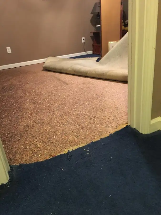 Carpet pad removal revealing water damage during Drying & Dehumidification in Natchitoches